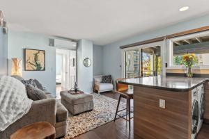 a living room with a couch and a table at Spa Creek Condo Pool Deck & Parking in Annapolis