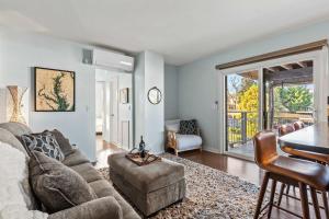 a living room with a couch and a table at Spa Creek Condo Pool Deck & Parking in Annapolis