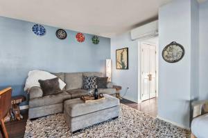 a living room with a couch and a table at Spa Creek Condo Pool Deck & Parking in Annapolis +34 photos