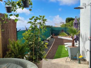 a garden with trees and plants on a patio at Abadog Canarias in Firgas