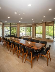 a large conference room with a large wooden table and chairs at Riverside Hotel & Restaurant in Acharistsqali +49 photos