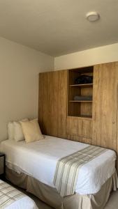 a bedroom with a bed with a wooden wall at Villa Evelia, Pool, Near Nuevo Vallarta in Mezcales +63 photos