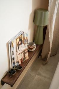 a table with a lamp and a picture on it at Playa del Ter in Platja de l'Arenal