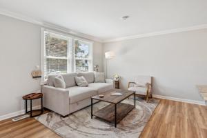 a living room with a couch and a table at Renovated 3BR Near Sandy Point Beach in Annapolis