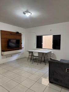 a room with a table and chairs and a window at Prédio Solar da Serra in Parauapebas