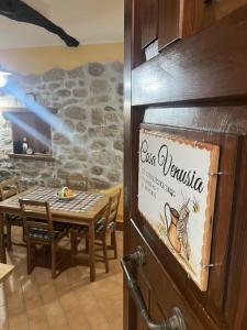 a restaurant with a table and a sign on a wall at Casa Venusia in Alatri