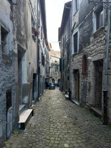 an alley with a car driving down a street at Casa Venusia in Alatri