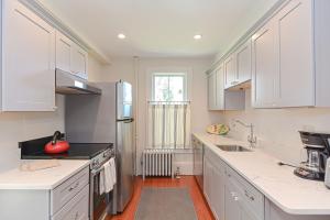 a kitchen with white cabinets and a stove top oven at Pigeon Hill in Rockport