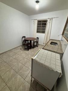 a room with a table and chairs and a table at Pousada Rubbi Violeta in Alto Paraíso de Goiás