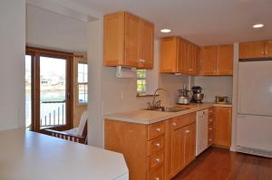 a kitchen with wooden cabinets and a counter top at River Watch in Gloucester +29 photos