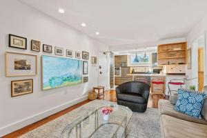 a living room with a couch and a table at Spa Creek Waterfront Pool & Parking in Annapolis