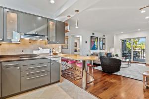 a kitchen with a table and a dining room at Spa Creek Waterfront Pool & Parking in Annapolis