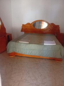 a bedroom with a bed with a mirror on it at Baraka Nema Villa Resorts in Gunjur