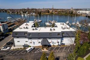 an aerial view of a large building with a marina at Captains Quarters Waterfront & Pool in Annapolis