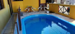 a large blue swimming pool in a room at Pousada dos Pássaros Pipa in Pipa