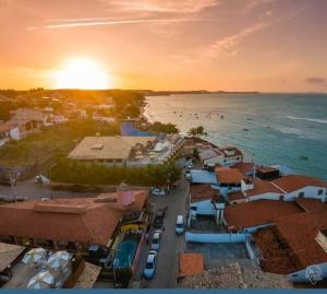 an aerial view of a beach with people in the water at Pousada dos Pássaros Pipa in Pipa