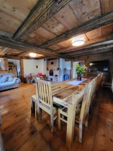 a dining room with a wooden table and chairs at Gajowe Zacisze in Mirsk