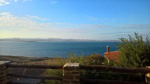 a view of the ocean from a wooden fence at Ethaleia Hotel in Moúdhros