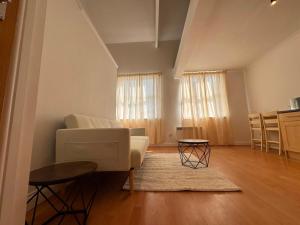 a living room with a couch and a table at Cosy 2 Story Home Leicester City Centre in Leicester