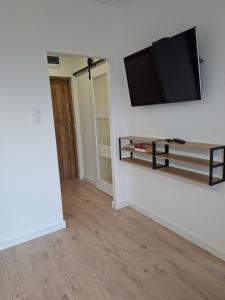 a living room with a flat screen tv on a wall at Diwo Apartament in Koszalin