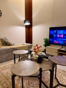 a living room with a couch and a tv at أورا ل التأجير اليومي للعائلات فقط in Jeddah