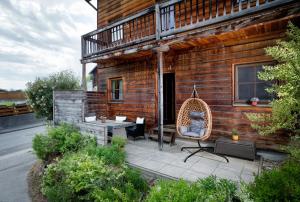 a house with a patio with a chair and a table at Feel Good Place in Fritzens
