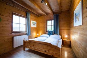 a bedroom with a bed in a wooden cabin at Feel Good Place in Fritzens