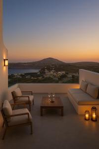 a living room with a couch and a table at Urano Cave Suites in Santorini