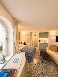 a hotel room with a bed and a living room at Villa Sain Charming Suite in Anacapri