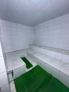 an empty room with green inside of it at Skylab Accomodationz in Kasangati