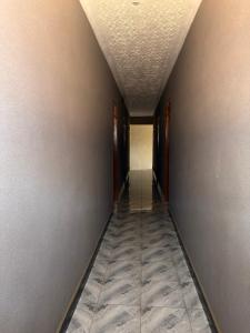 an empty hallway with a long corridor at Skylab Accomodationz in Kasangati
