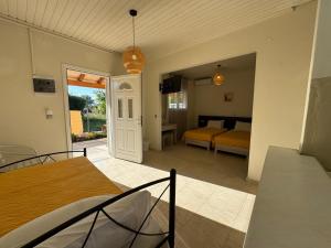 a bedroom with a bed and a living room at Antilia Corfu 1 in Agios Georgios