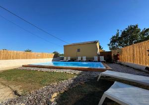a swimming pool in a yard next to a fence at Antilia Corfu 1 in Agios Georgios