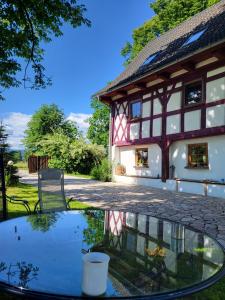 a house with a glass table in front of it at Gajowe Zacisze in Mirsk