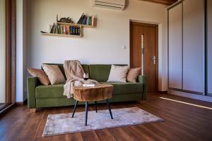 a living room with a green couch and a table at Nad Drwęcą in Mszano