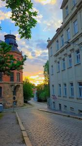 a building with a tower next to a street at Spacious Flat with 3 bedooms for 5-8 guests in Zeitz