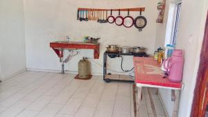 a kitchen with a counter and a table in a room at Baraka Nema Villa Resorts in Gunjur +22 photos