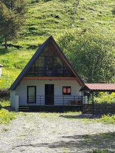 a house with a large window on the side of it at kazbegi - Sno Mountain House in Sno
