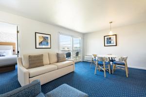 a living room with a couch and a table in a room at Aspinquid Resort in Ogunquit +50 photos