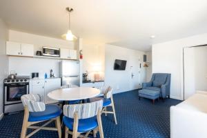 a kitchen and living room with a table and chairs at Aspinquid Resort in Ogunquit