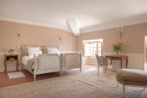 a bedroom with a bed and a table and a chair at Château du Grand Pré in Vitrolles-en-Luberon +50 photos