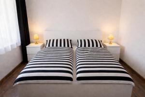 a bedroom with two beds with two lamps on them at Klidná Chalupa in Bulhary