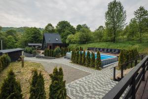 a garden with a swimming pool and a house at Shale Maidan in Maidan Village