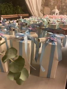 a row of tables with wrapped boxes with bows at San Rocco Relais in Soiano del Lago +64 photos