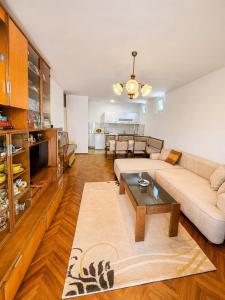 a living room with a couch and a table at Igalo Apartment in Igalo +4 photos