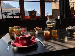 a table with a plate of food on top of a table at Beau Refuge du Galibier in Le Monêtier-les-Bains