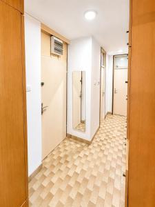 an empty corridor with a door and tile floor at Igalo Apartment in Igalo