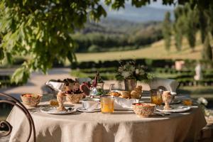 a table with food and drinks on it at Château du Grand Pré in Vitrolles-en-Luberon