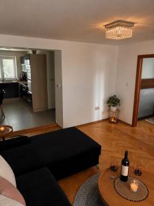a living room with a black couch and a table at Apartmán Višňovka in Pardubice +5 photos