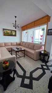 a living room with a couch and a table at Star beach in M'diq
